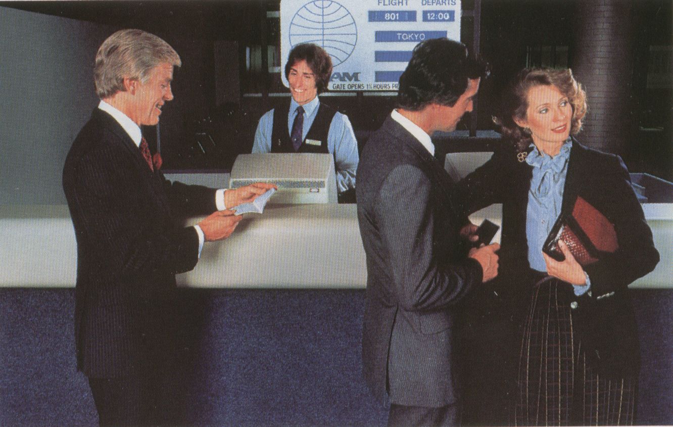 1981 A Passenger Service Agent assists customers at a departure gate counter at New York JFK Airport.